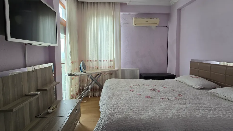 Изображение просторной и светлой спальни в дуплекс-апартаментах с видом на море в Бодруме.